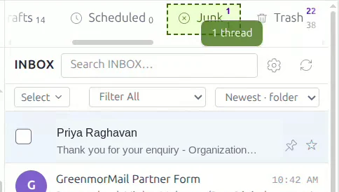 A message being dragged onto the Junk folder, which is highlighted as a drop target